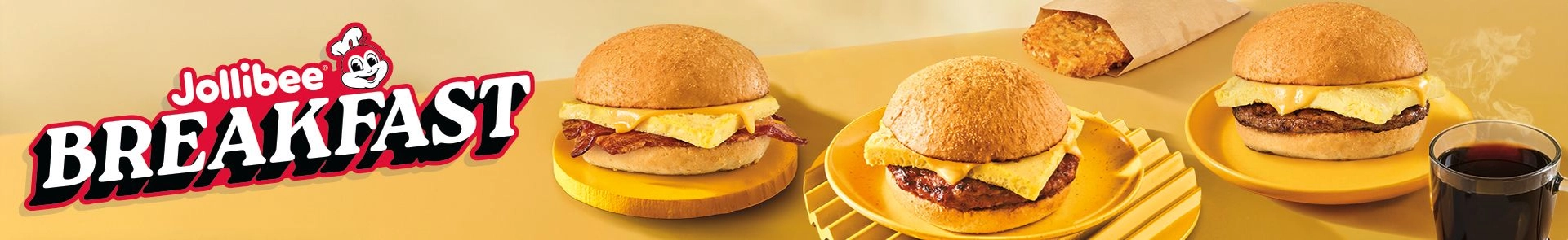 Three breakfast pandesal sandwiches with hash browns and coffee, and Jollibee Breakfast text on a yellow background.